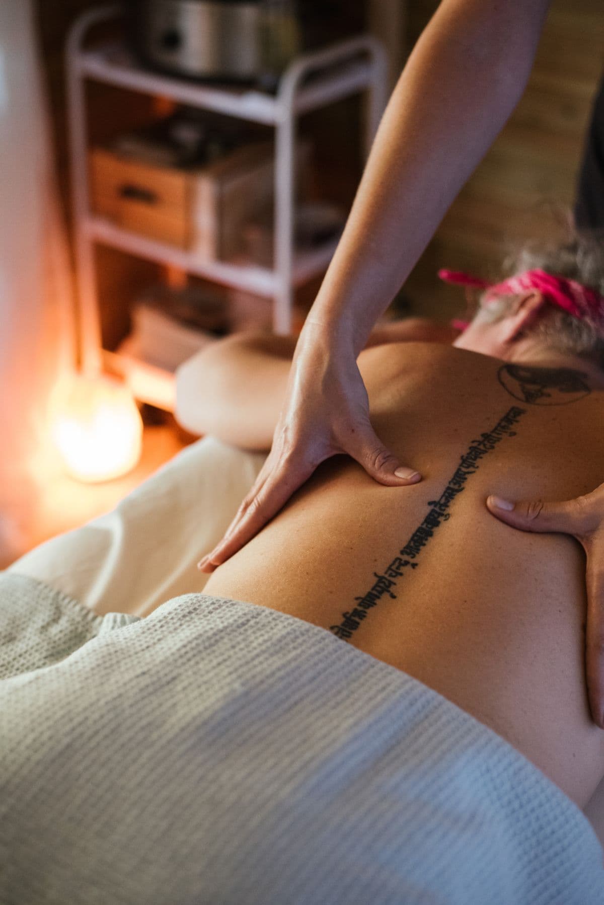 Private Signature massage — warm light, intimate atmosphere, delivered to your room